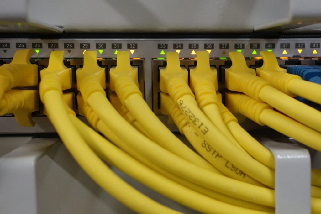 10 Reasons why you need to move to SD-WAN now. a picture of a network switch and RJ45 patch cables illustrating a network